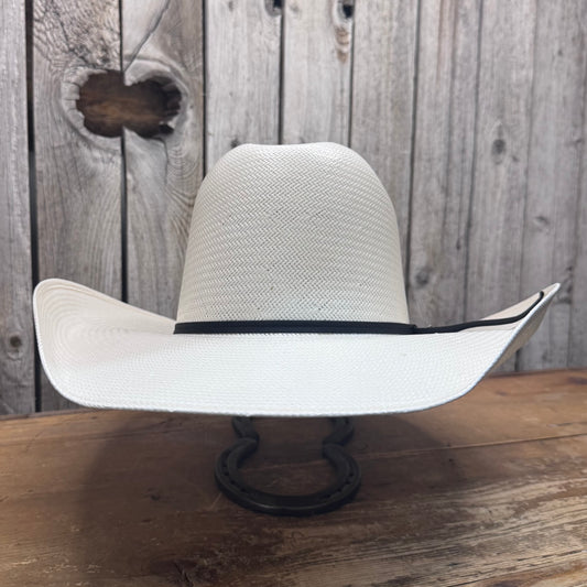 White shatung cowboy hat with a 4 1/4 inch brim displayed on a stand against a wooden background.