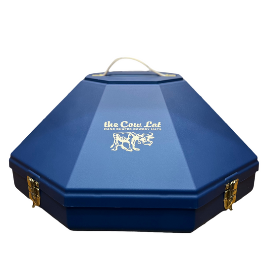A navy blue hat can with metal clasps and a handle, featuring a white logo on the top lid.