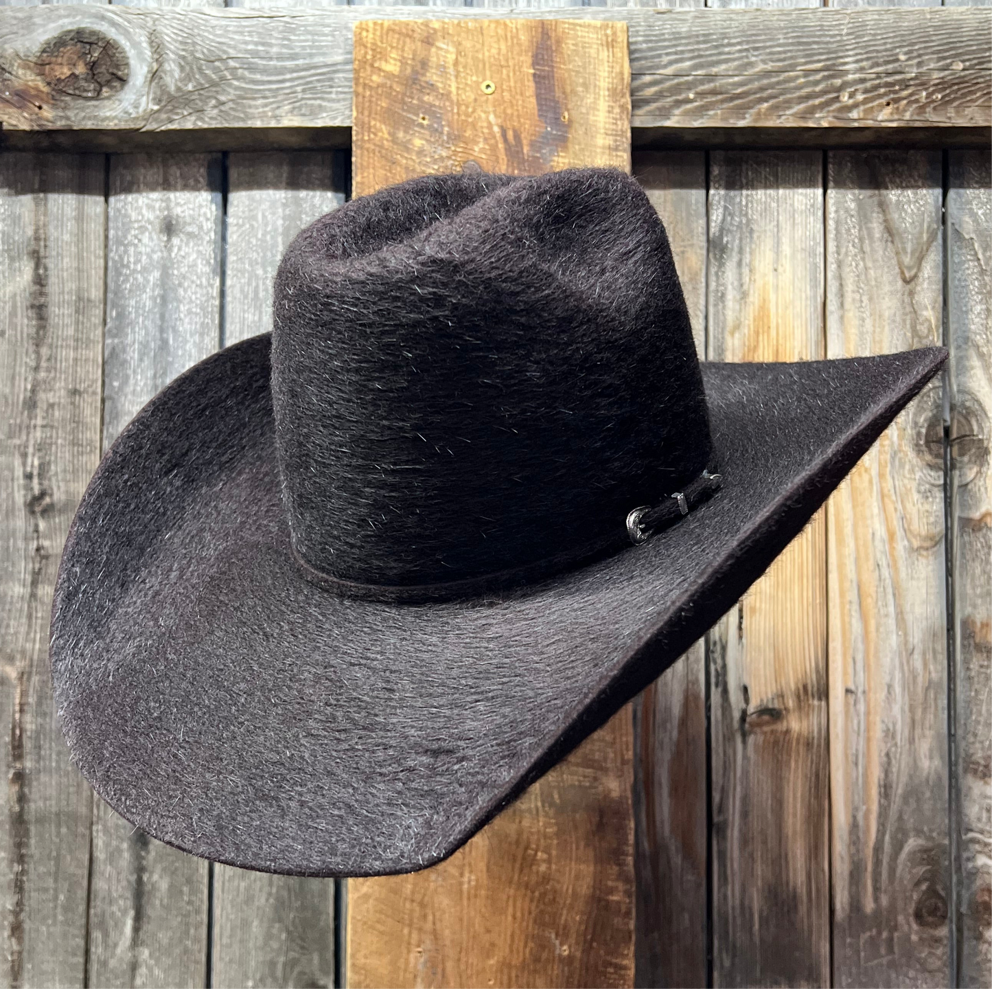 Black cowboy hat on a wooden surface
