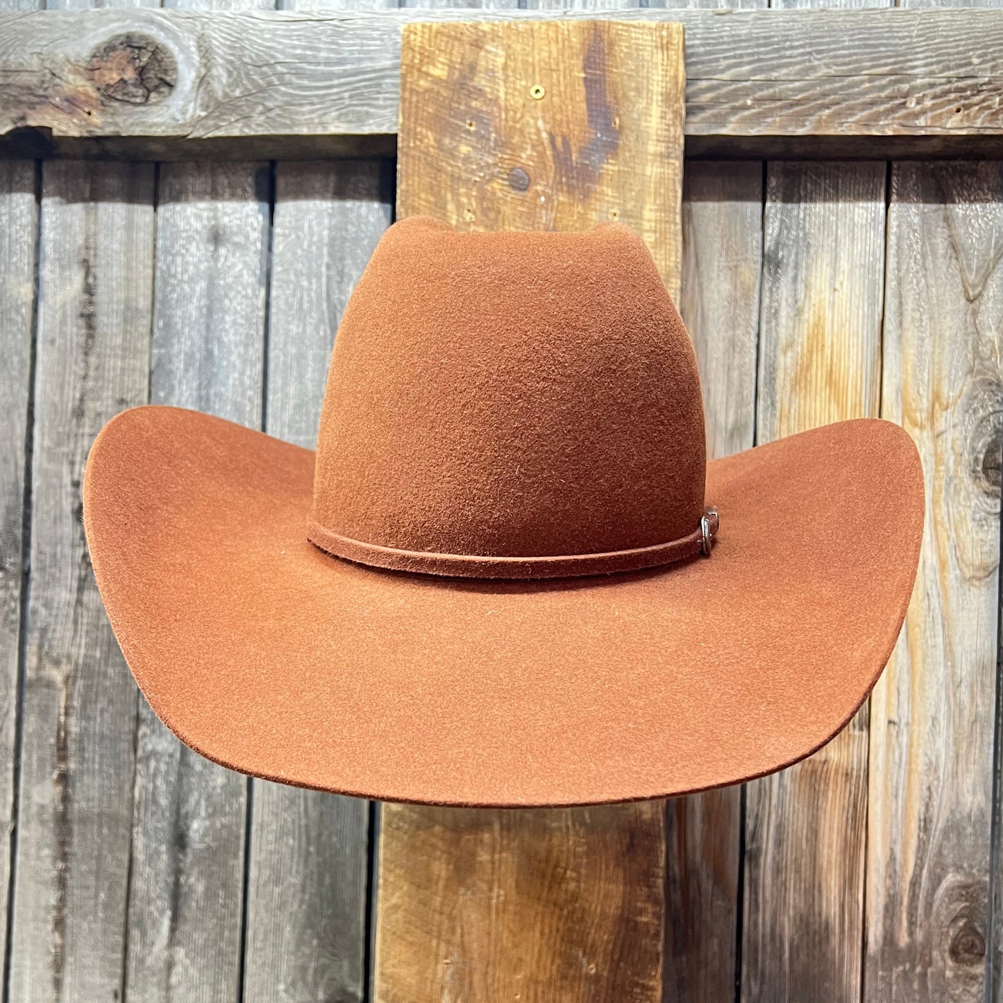 Brown cowboy hat on a wooden surface