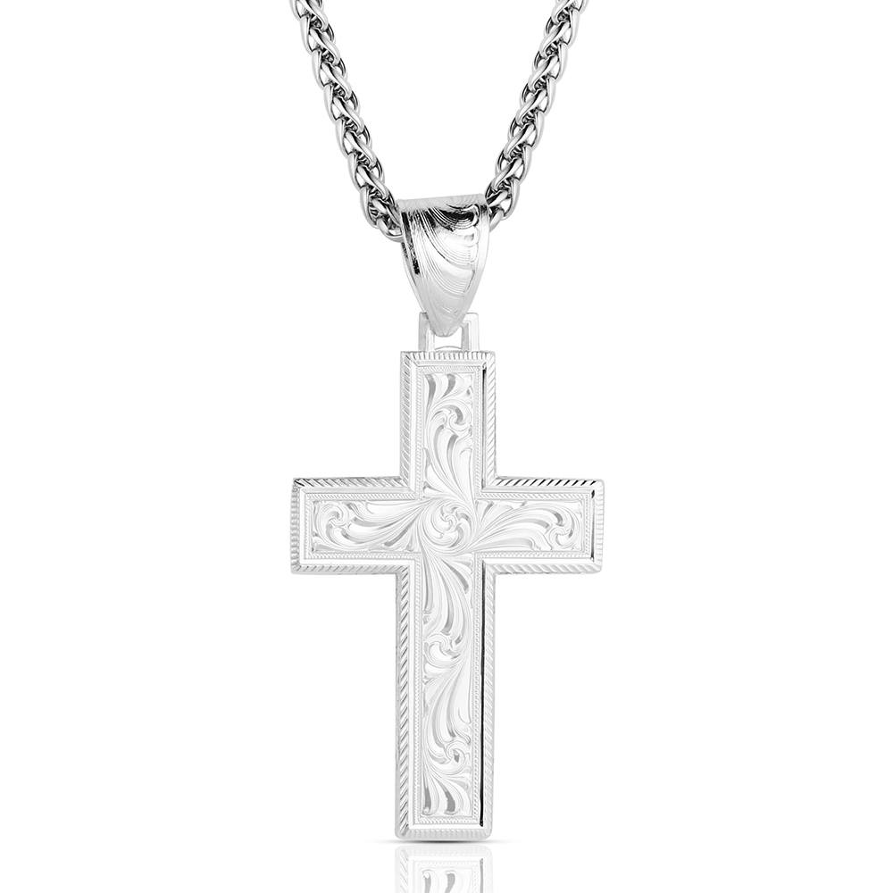 Silver cross pendant on a chain against a white background