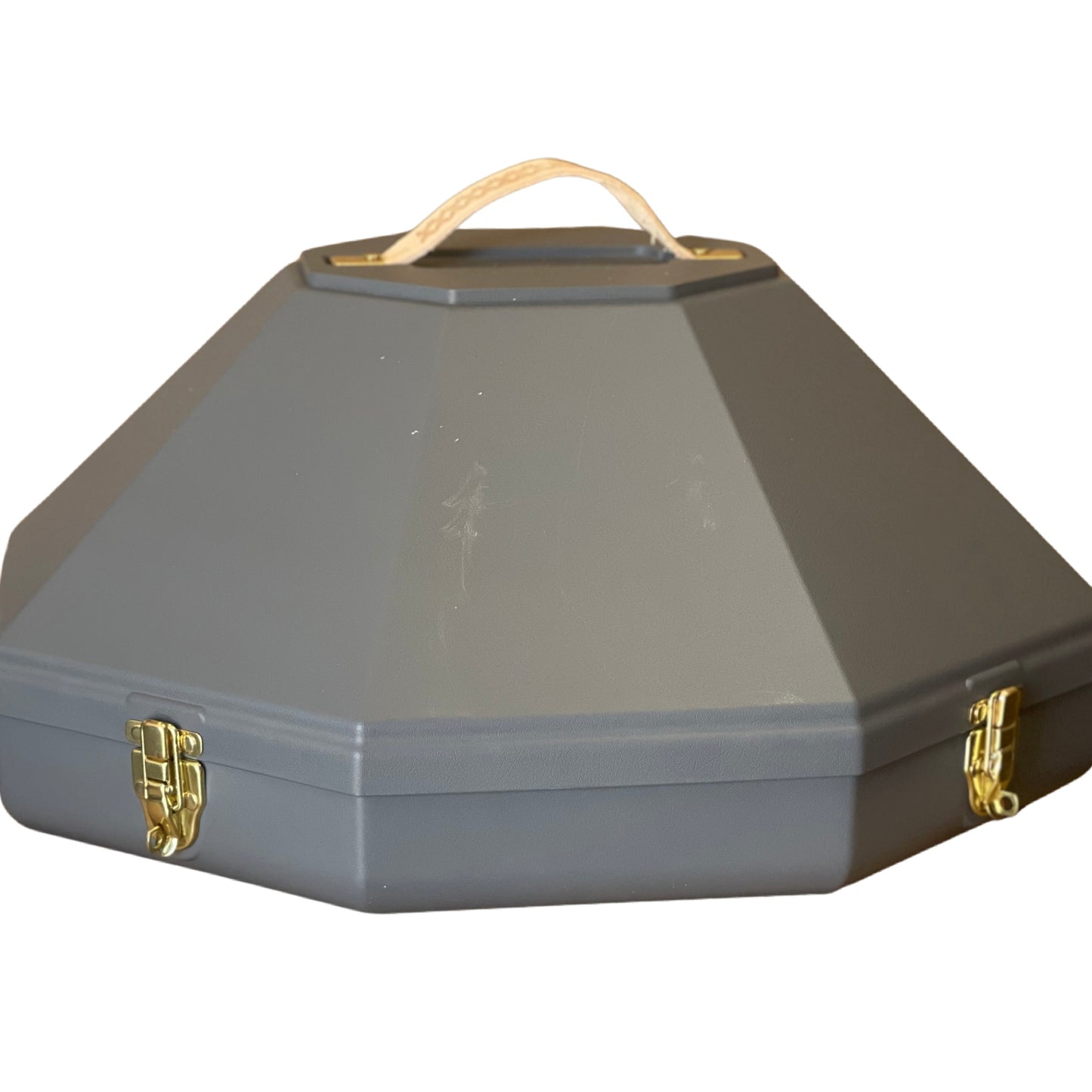 A gray hat canister with a handle on top and metal clasps. It appears to be made of metal and is designed to store a hat.