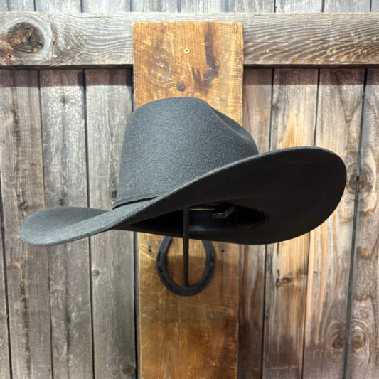 Black cowboy hat on a wooden wall