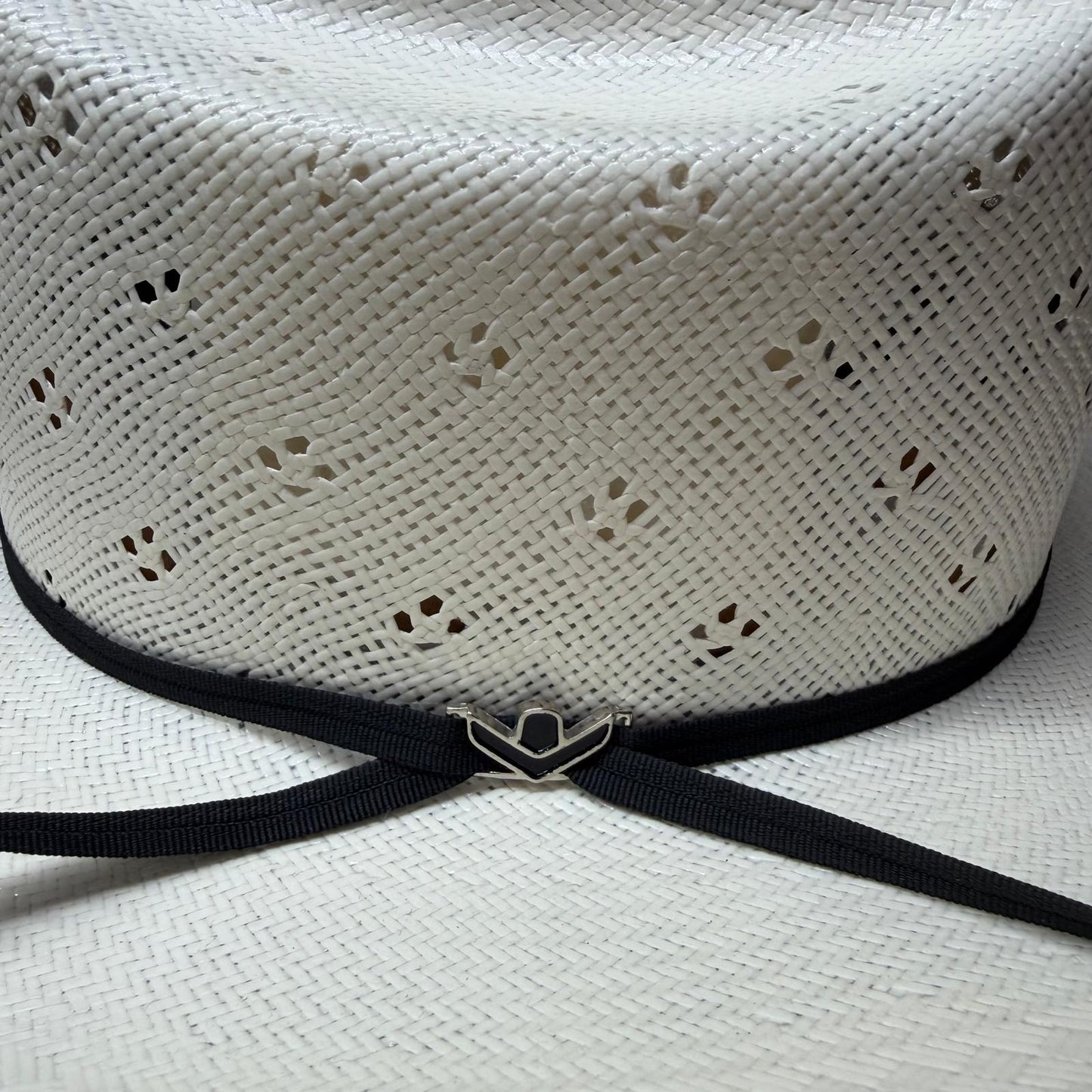 White straw hat with a black band and prohat black pin 