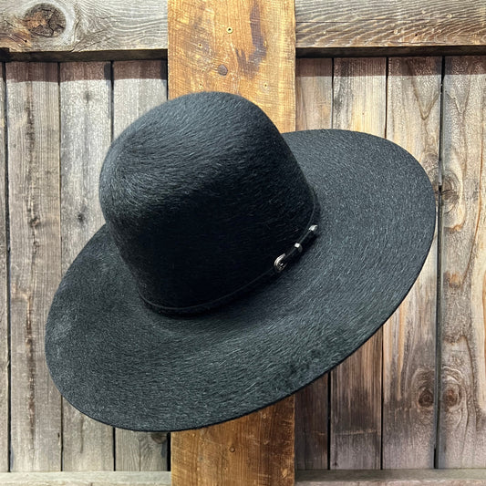 Grizzly Black hat hanging on a wooden wall