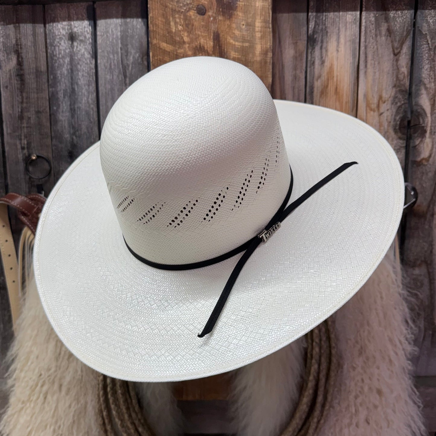White straw hat with a black band on a wooden background