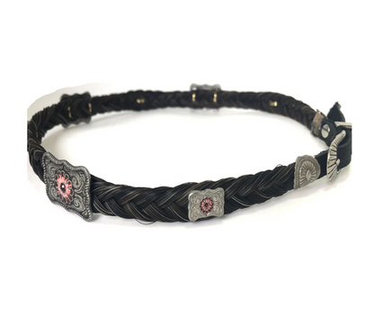 Black braided hat band with decorative metal buckles on a white background