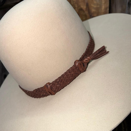 Brown braided leather belt on a white mannequin head
