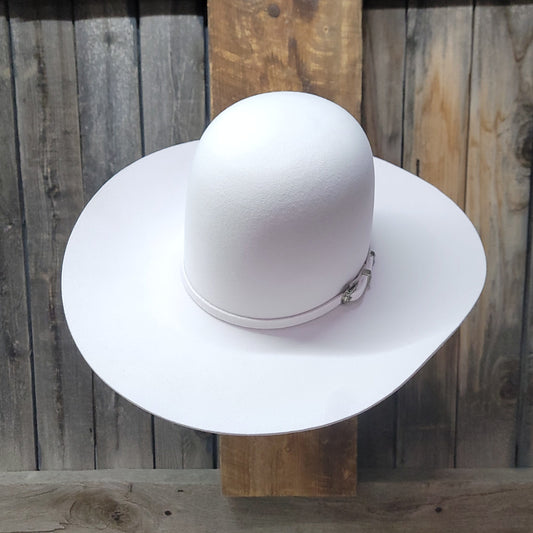 White wide-brimmed hat on a wooden surface with a wooden panel background